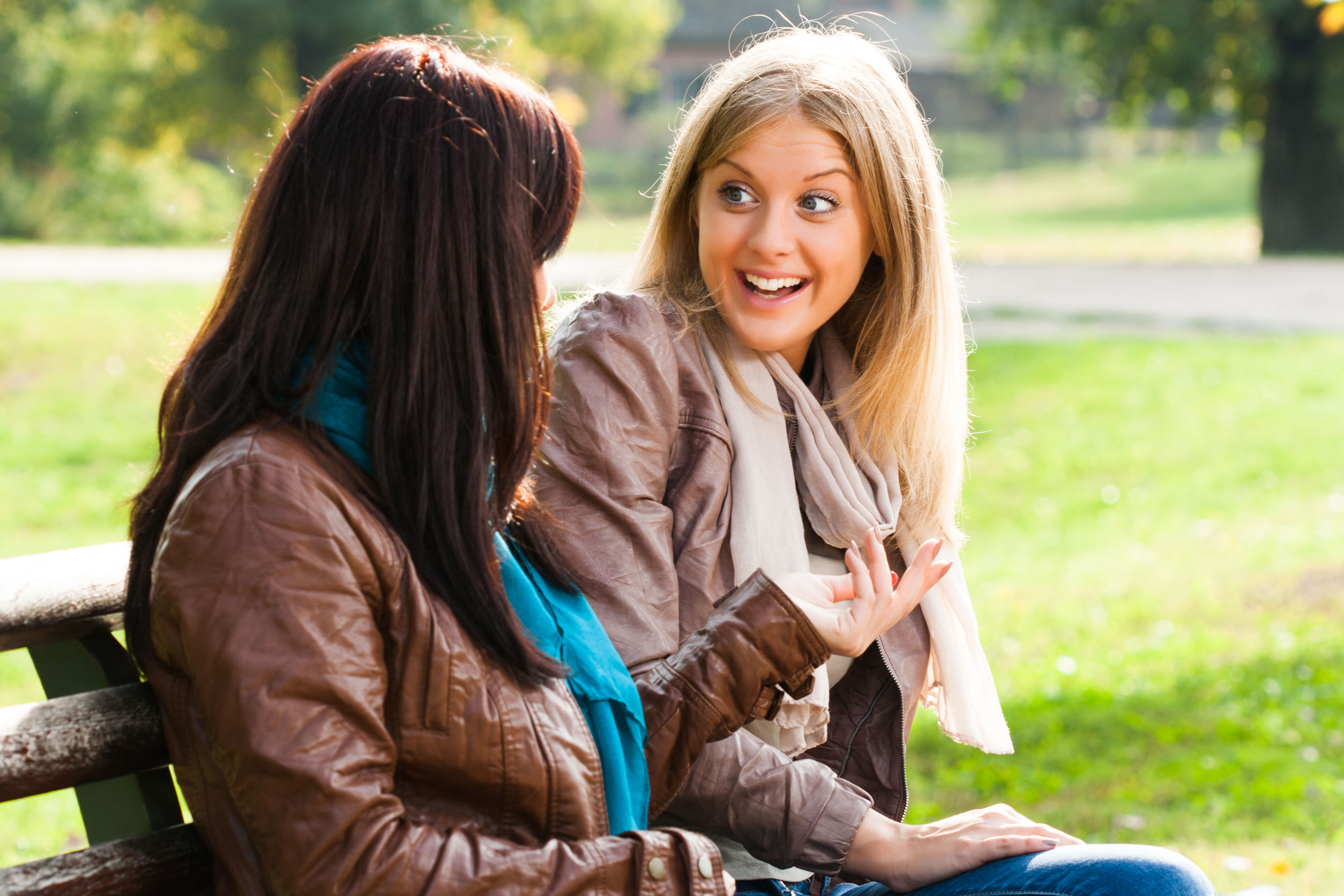 Two women in conversation on park bench
